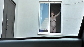 Neighbor taxi driver from looks at neighbor MILF who washes window of apartment naked. Nude in public