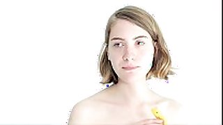 Teasing golden-haired playgirl playing with a banana