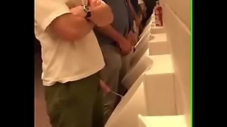 Pissing bro at be passed on ballgame urinal
