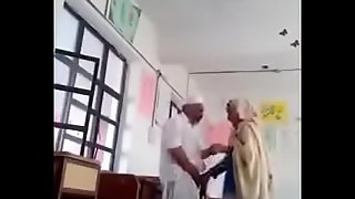 A 70 yrs old man dealings with 30 yrs bold lady in classroom.